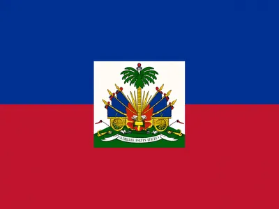 Haitian flag with blue and red horizontal stripes and a white square at the center displaying Haiti's national coat of arms.