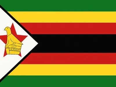 Flag of Zimbabwe with seven horizontal stripes in green, gold, red, and black, and a white triangle featuring a red star and a yellow bird.
